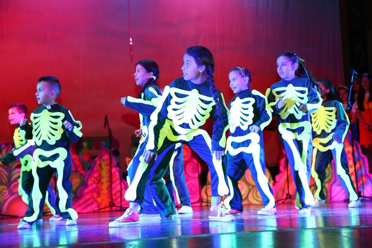 Dancers in glow-in-the-dark skeleton costumes