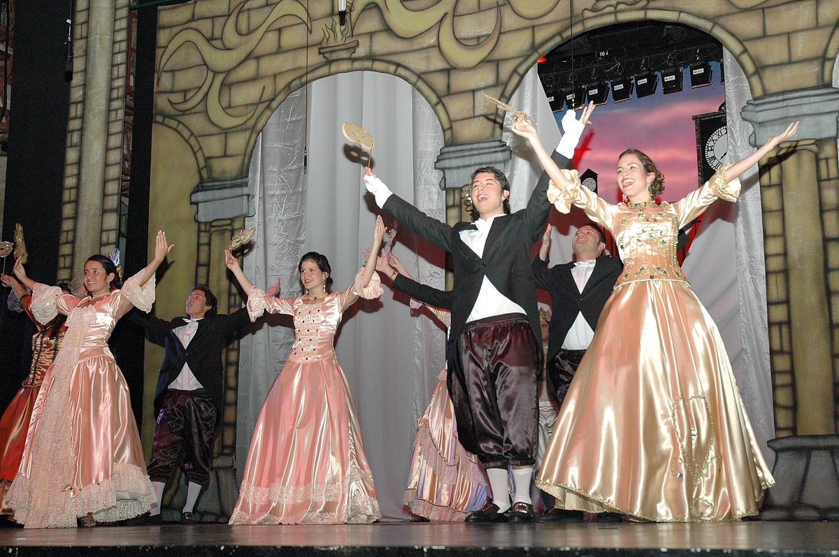 A ballroom scene with period dresses