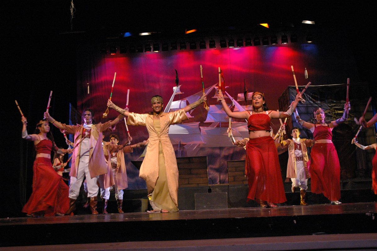 Dancers in red in a group scene