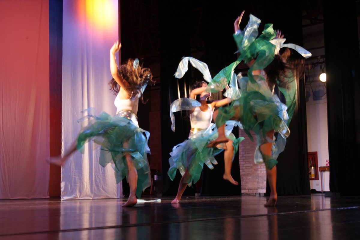 Dancers in green feather costumes