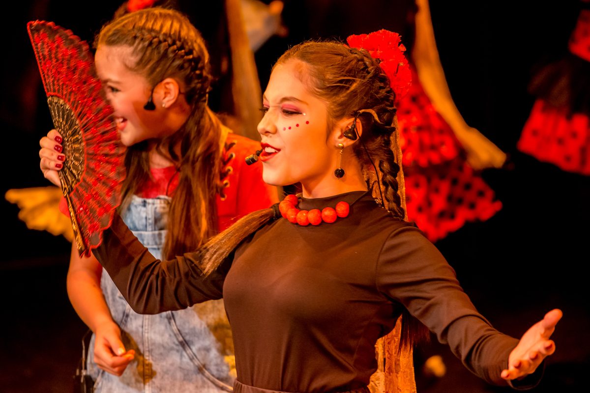 Two girls with braids in colourful costumes